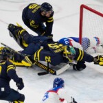 Sweden's goalkeeper Jacob Markstrom makes a save during a preliminary round match of men's ice hockey between Sweden and Slovakia at the 2026 Winter Olympics, in Milan, Italy, Saturday, Feb. 14, 2026. (AP Photo/Petr David Josek)