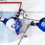 Italy's Mats Frycklund (67) shoots during a preliminary round match of men's ice hockey between Italy and Slovakia at the 2026 Winter Olympics, in Milan, Italy, Friday, Feb. 13, 2026. (AP Photo/Darko Bandic)