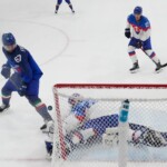 Italy's Mats Frycklund (67) shoots during a preliminary round match of men's ice hockey between Italy and Slovakia at the 2026 Winter Olympics, in Milan, Italy, Friday, Feb. 13, 2026. (AP Photo/Darko Bandic, Pool)
