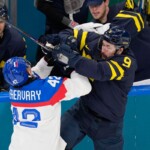 Slovakia's Martin Fehervary, left, challenges Sweden's Filip Forsberg during a preliminary round match of men's ice hockey between Sweden and Slovakia at the 2026 Winter Olympics, in Milan, Italy, Saturday, Feb. 14, 2026. (AP Photo/Petr David Josek)