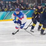 Slovakia's Juraj Slafkovsky, left, skates on ice during a preliminary round match of men's ice hockey between Sweden and Slovakia at the 2026 Winter Olympics, in Milan, Italy, Saturday, Feb. 14, 2026. (AP Photo/Petr David Josek)